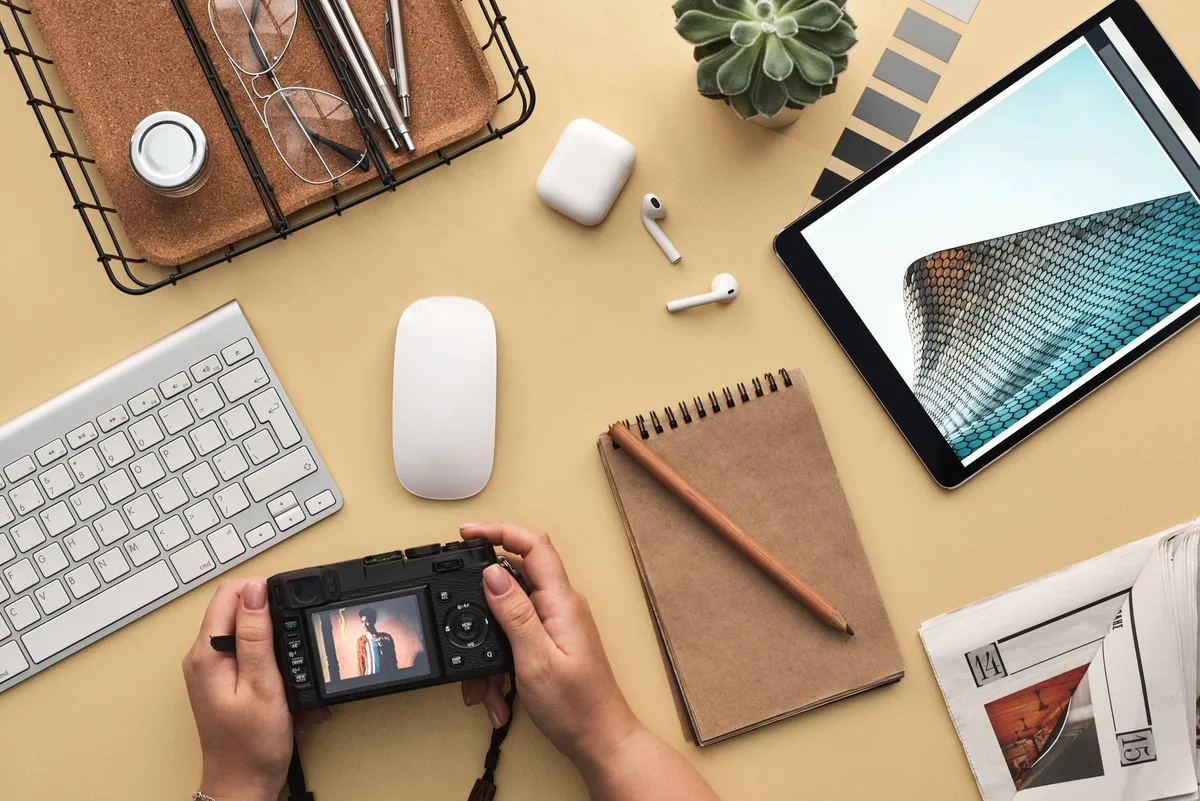A focused man uses a tablet to design while working at his desk in a modern office setting