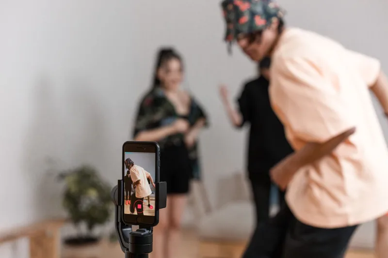 Person filming a TikTok video with on-screen text overlay displayed prominently in the opening frame