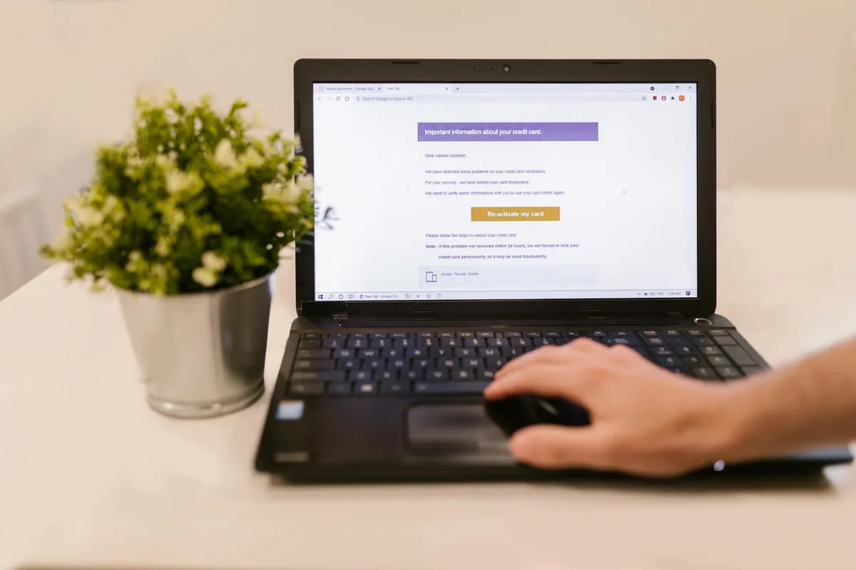 Clean minimal desk workspace with an open laptop showing an email dashboard