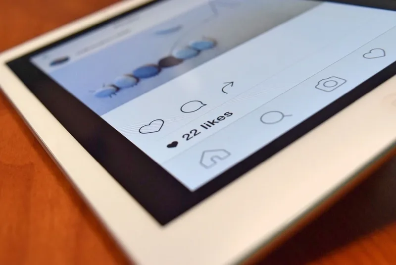 Instagram Insights dashboard on a phone showing engagement rate and reach breakdown across recent posts