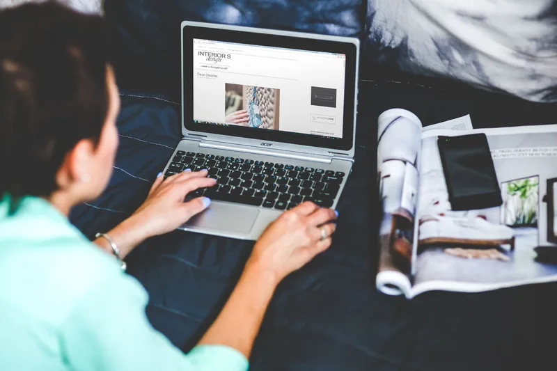 Creator editing a newsletter draft on a laptop, reviewing and cutting paragraphs before sending