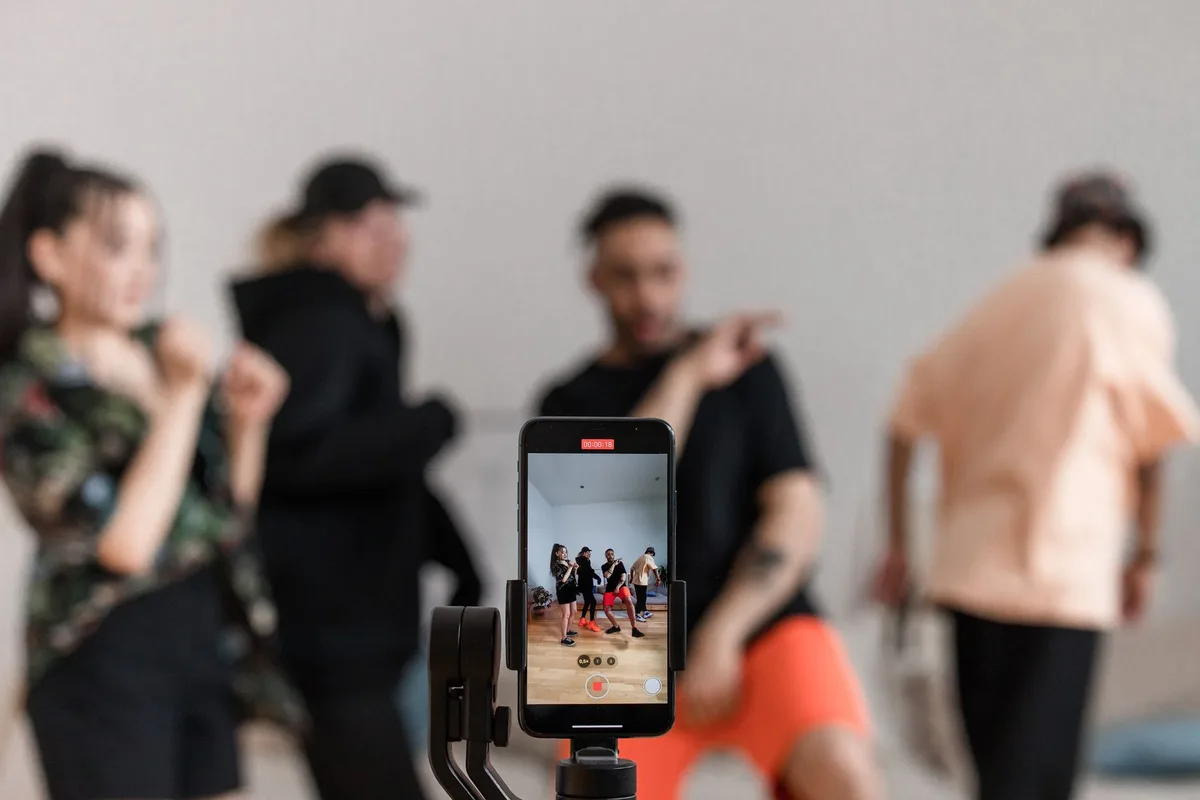 Two people looking at phones together, representing Instagram collab post collaboration