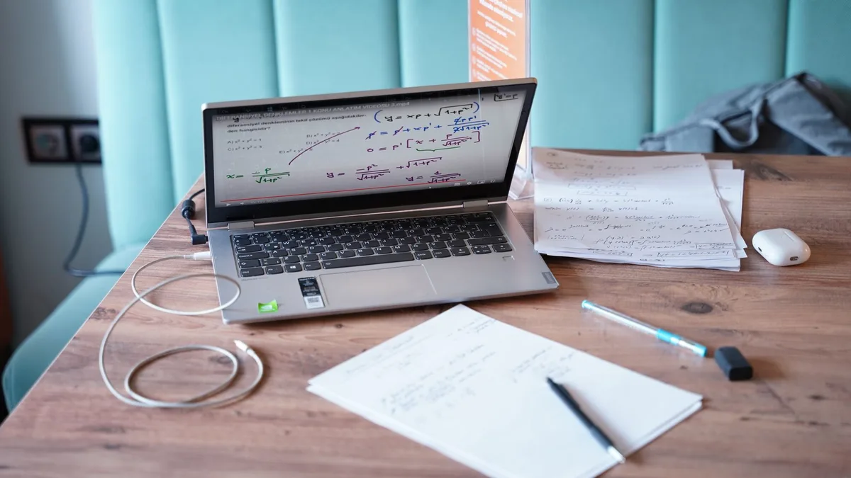 Person typing at a clean desk with a laptop, representing focused LinkedIn content creation