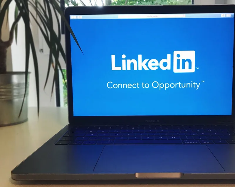 Open laptop showing a social media profile page on screen, representing LinkedIn profile optimization