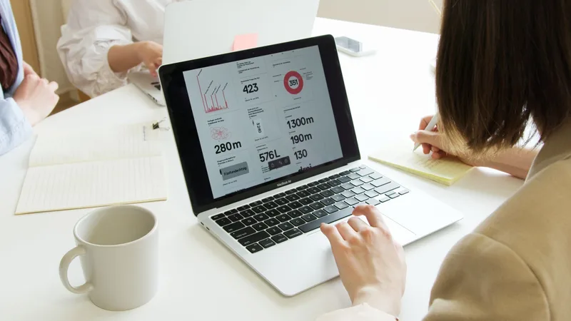 Laptop showing an analytics dashboard on screen representing YouTube Studio CTR tracking and performance data